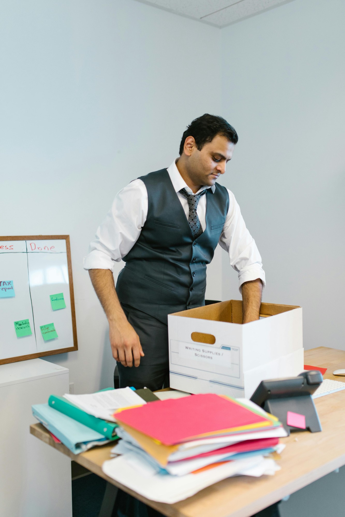 Employee packing belongings into a box — departing-employee forensics
