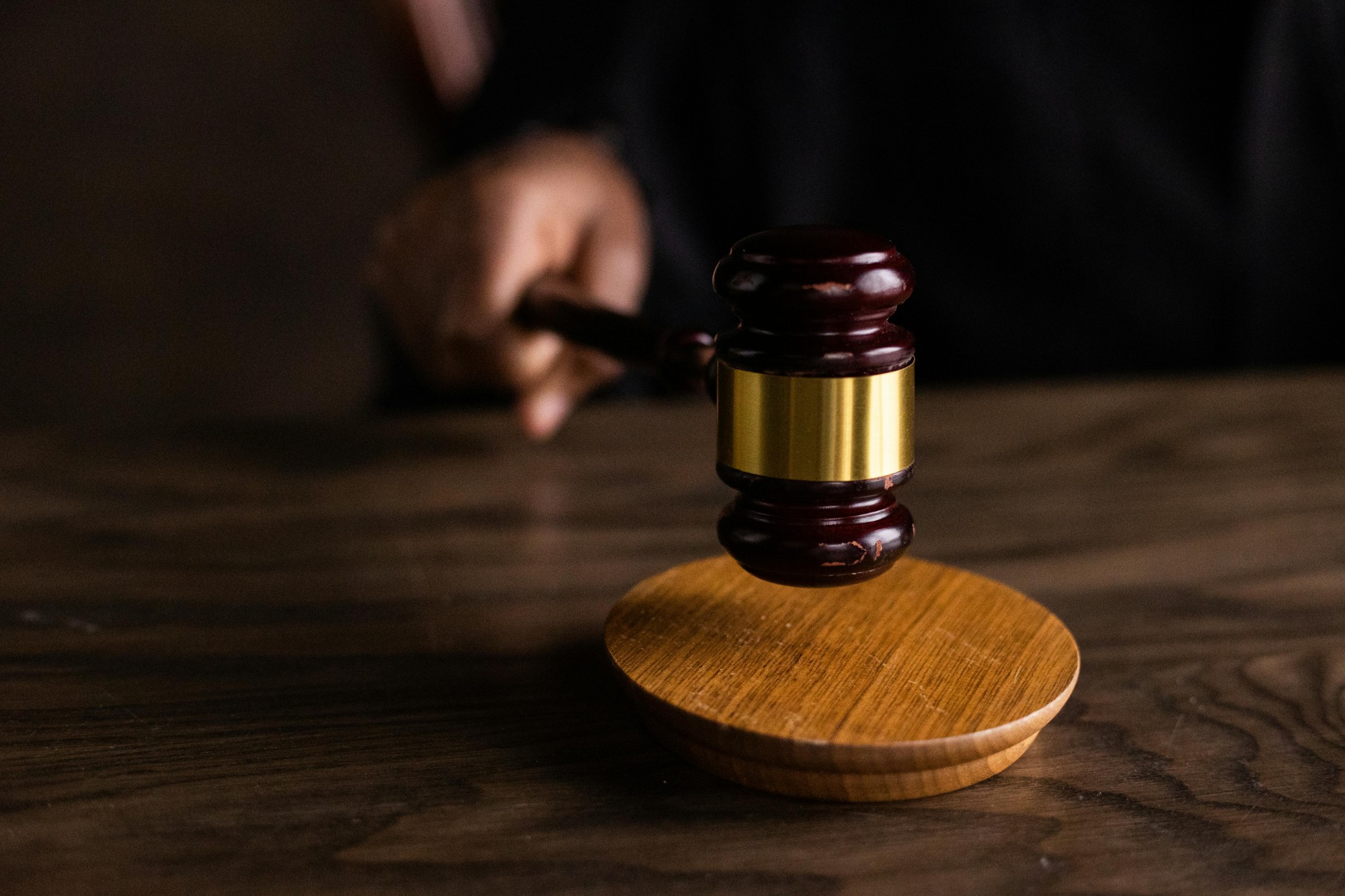 Judge's gavel on a wooden bench — built for the courtroom