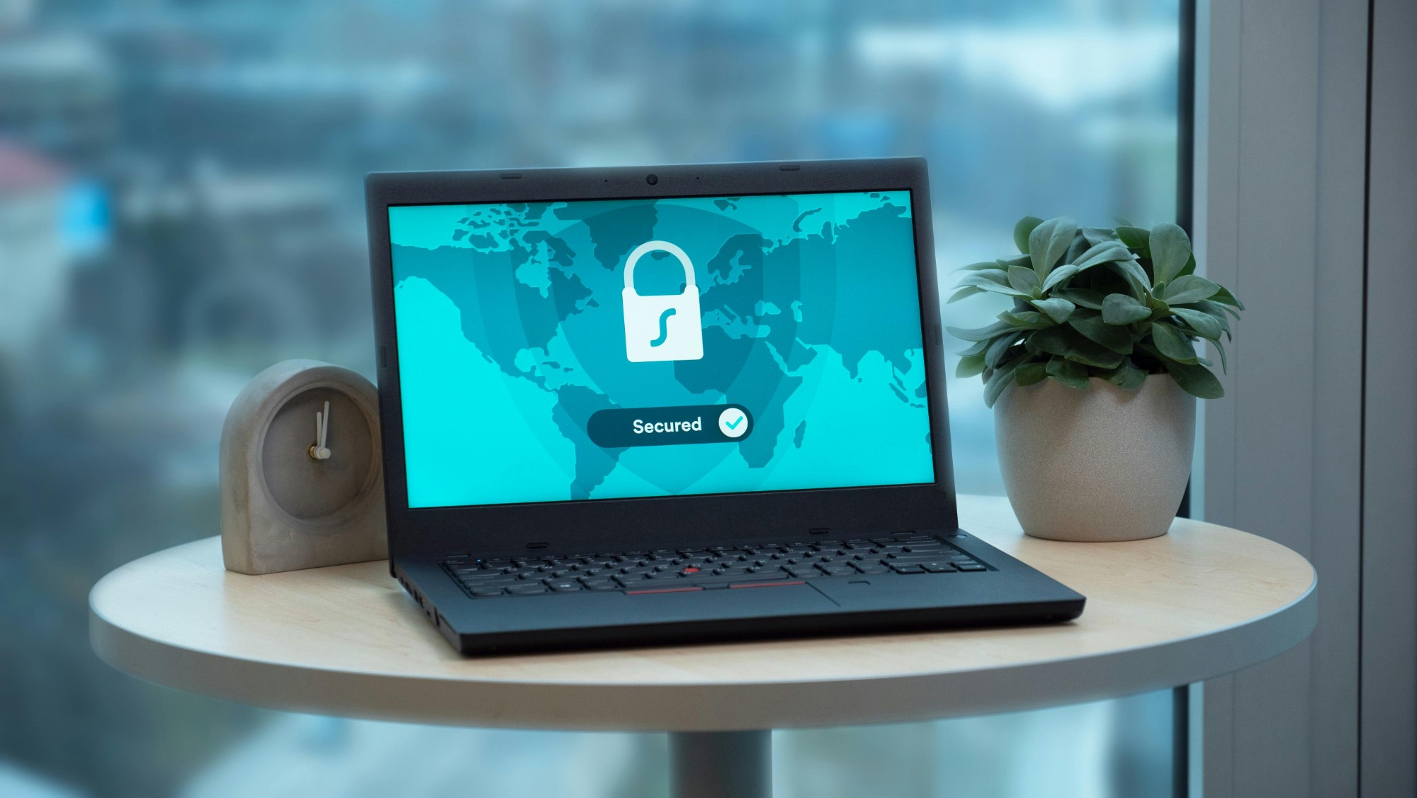 Laptop showing secured padlock on world map — secure device decryption