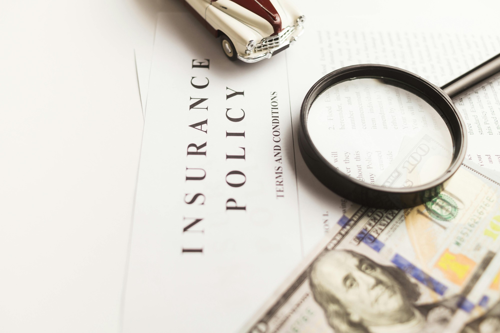 Insurance policy document with magnifying glass